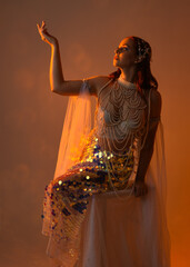 Fantasy studio portrait of a red-haired mermaid faery model wearing white pearl gown, fairytale...