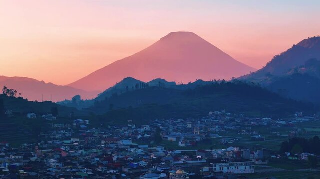 Mt. Sindoro Sumbing over Dieng Village with beautifull sunrise in Dieng, Indonesia.