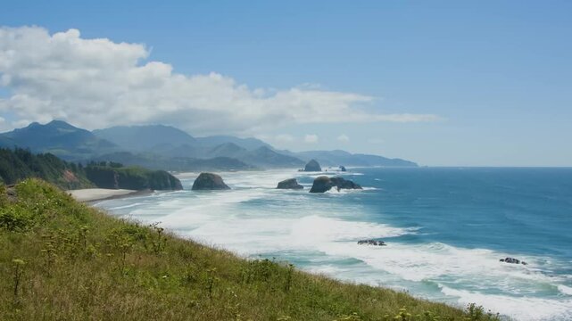 Footage highlights the rocky Oregon Coast from Oswald West State Park with lush forests and crashing surf forming a classic Pacific Northwest scene.