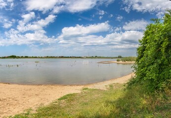 spring flood on the Kuban River - rising water flooded the beach soccer field on a sunny spring day