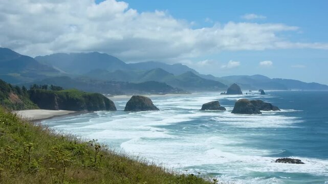 Footage shows a classic Oregon Coast scene with sharp cliffs, green woods, and white surf, typical of Oswald West State Park lookouts.