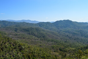Fototapeta premium Distant Mountains and Forest with Trees and Sky in Northern Thailand.