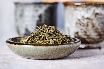 Dried Green Tea Leaves on Bright Background. Close up.	