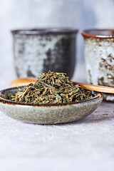 Dried Green Tea Leaves on Bright Background. Close up.	