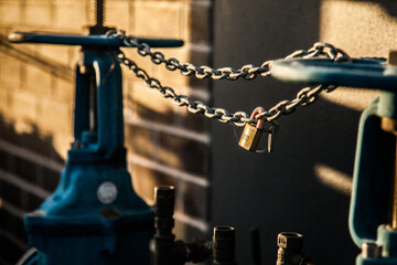 Lock on wheels and chains on a blue water hydrant