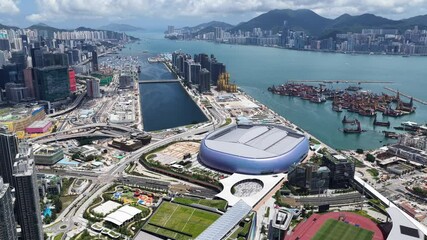 Hong Kong Kai Tak Sports Park includes a world-class multi-purpose main venue with retractable canopy and coastal dining area by seaside Victoria Harbour connected Station Metropolitan Park