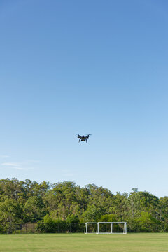 A drone, or UAV, or RPAS hovering over a football field - unmanned aerial vehicle