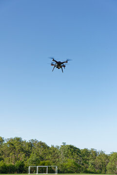 A drone, or UAV, or RPAS hovering over a football field - viewed close up unmanned aerial vehicle