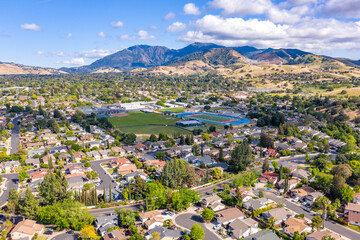 Aerial drone view of Concord, California, featuring residential neighborhoods, a sports complex,...