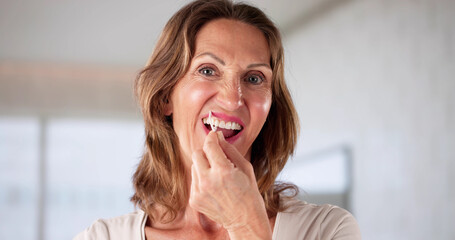 Woman With Dental Floss To Clean Teeth, Orthodontic Brackets Corrected