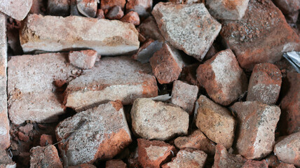 This old stone wall shows a rough rock texture and pattern, a material commonly used in architecture and building construction, creating a textured surface with a brown, natural backdrop