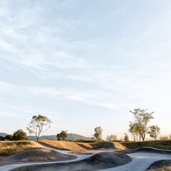 Naklejka premium Golden Hour on a Remote Dirt Biking Track, Adventure Ride Through Rolling Hills and Dirt Trails, Navigating Curved Tracks in Arid Landscape