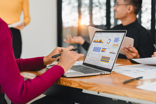Data analysis meeting with business team using laptop and digital chart for project planning and strategy in modern office environment