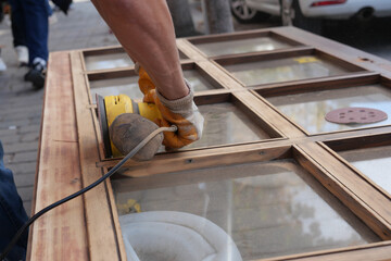 Wooden surface being sanded in a city setting