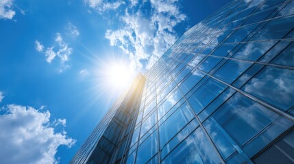 Fototapeta premium Glass building reflects sky and sun showing architecture and construction
