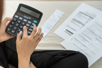 woman with large bills or invoices no money to pay to expenses and credit card debt. shortage,...