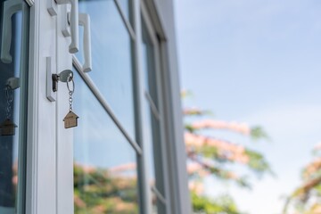 unlocking house is plugged into the door. Second hand house for rent and sale. keychain is blowing...
