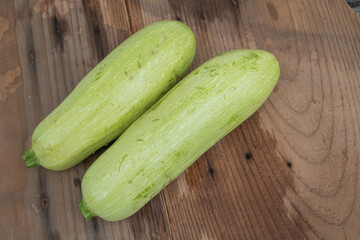 Two Fresh Zucchinis on Rustic Wooden Table
