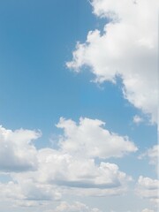 A bright blue sky with puffy white clouds.