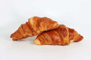 Buttery croissant isolated on a white background. Golden and flaky French pastry.