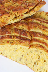 Sliced corn bread isolated on a white background. Golden crust and soft yellow interior