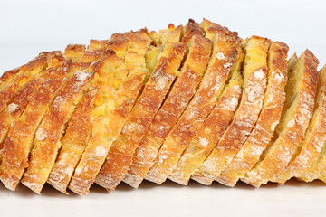 Sliced corn bread isolated on a white background. Golden crust and soft yellow interior