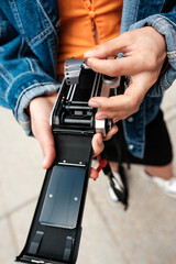 Photographer loading film into vintage analog camera