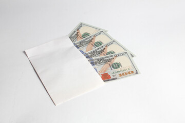 envelope containing dollar bills filled to capacity isolated on white background