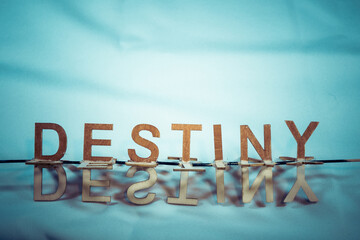 The word destiny with reflection below on a blue background.