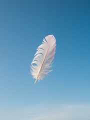 A single white feather is flying through blue sky.