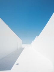 A street with white walls and blue sky.