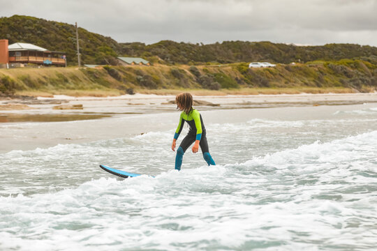 Young boy learning to surf in Portland Victoria