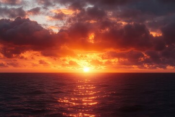 Vibrant orange and purple sunset over calm ocean waters with dramatic scattered clouds reflecting warm light on the sea, evoking serenity and awe