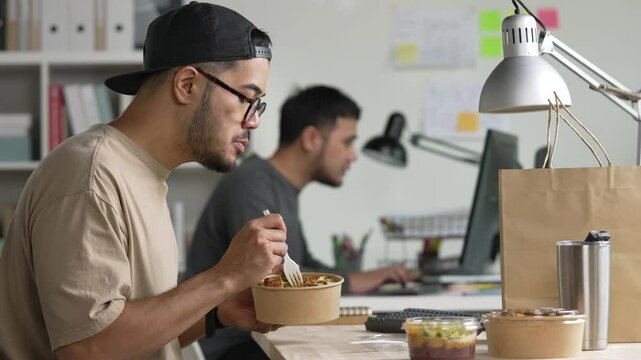 Man eating healthy meal while working, Businessman having a lunch break at the office