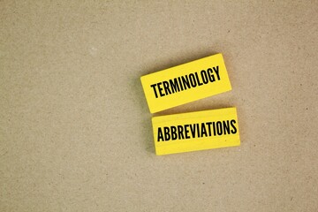 Yellow wood with the words terminology and abbreviations.