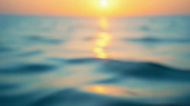 Abstract aerial sea summer ocean sunset nature background. Small waves on calm water surface in motion blur with golden bokeh lights from sun. Holiday, vacation and recreational concept. Slow motion