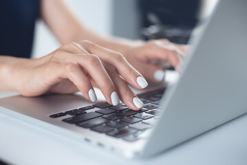 Business woman typing on laptop computer keyboard on office table, close up. online job, surfing the internet, remote work concept