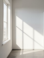 Fototapeta premium An empty room with white walls and wooden floors.