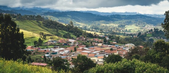 Fototapeta premium Scenic Andean town nestled amongst rolling hills, under a dramatic cloudscape