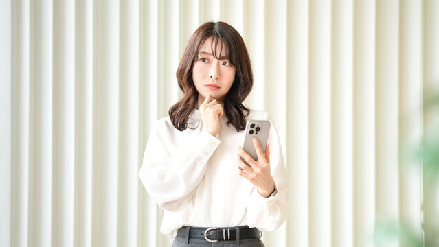 スマホ・悩む・考える女性・ビジネスウーマン