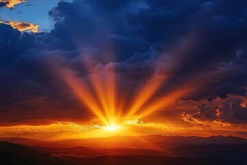 Fototapeta premium Dramatic sunset over rolling hills with radiant golden sun rays breaking through dark storm clouds on the horizon