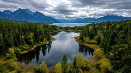 Fototapeta premium Scenic view of lake in pine forest with cloudy summer sky concept. Scenic view of a tranquil lake surrounded by mountains and forest.