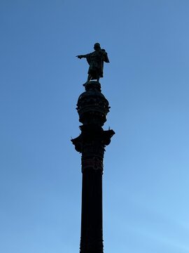The historic Columbus Monument (Mirador de Colom) rises with its ornate bronze statue at the top, overlooking Barcelona&rsquo;s waterfront.