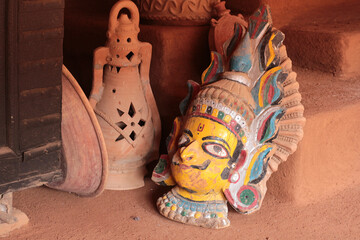 Traditional Indian Clay Mask, Bowl, and Lamp on Display