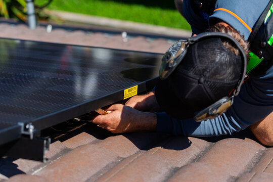 pv string disconnection point label on solar panel system with electrician wiring up panels