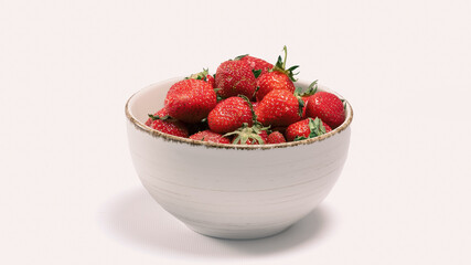 Freshly picked strawberries in a white bowl ready for enjoying or serving at a summer gathering or celebration