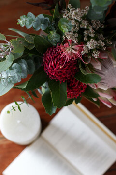 Above angle close up of native floral arrangement with notebook in the background