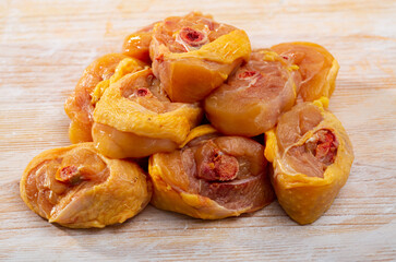 Close up of uncooked sliced transversely chicken legs on wooden background