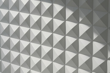 Obraz premium Textured wall featuring a geometric pattern of three-dimensional white pyramids casting soft shadows, creating a modern and minimalistic aesthetic in interior design
