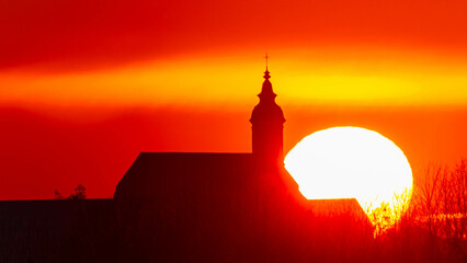 Megazoom (600mm) summer sunset or sundowner with Basilika Altenmarkt silhouette seen from near...